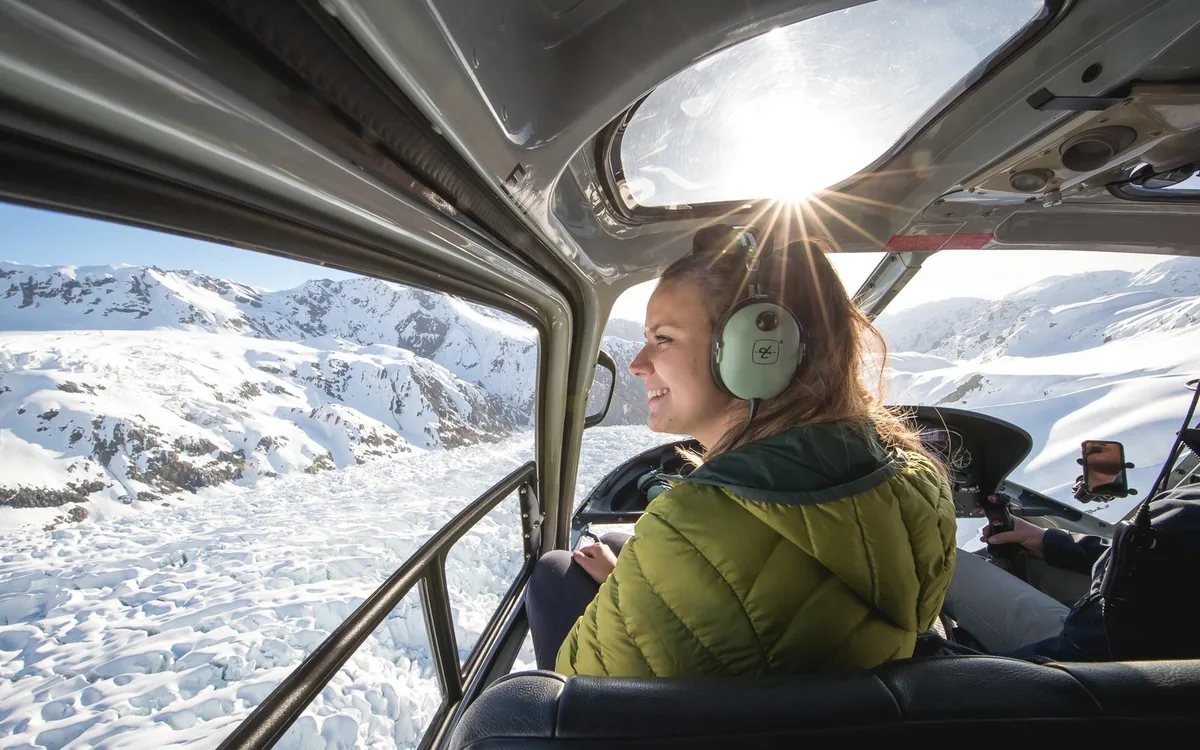 The view forward from inside a helicopter cabin flying up the Franz Josef valley