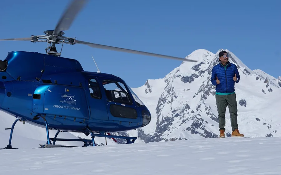 A blue helicopter on an alpine landing site above Franz Josef Glacier